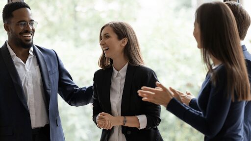 two men and two women smiling and talking