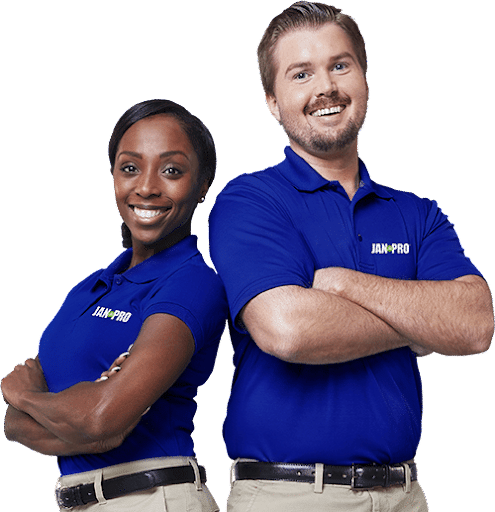 two JAN-PRO Cleaning & Disinfecting employees smiling with their arms crossed