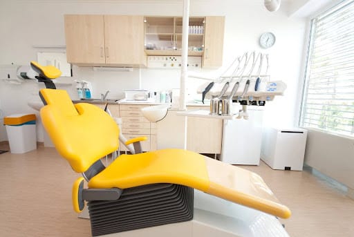 a medical office with a yellow medical chair