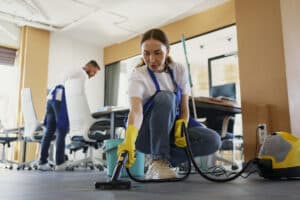 commercial cleaner vacuuming a carpet.