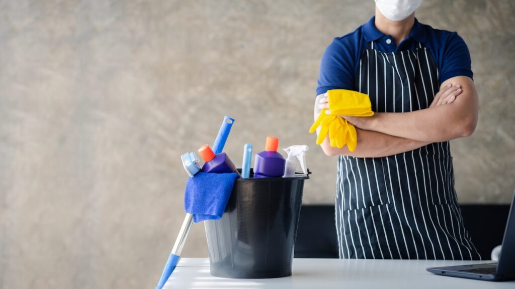 Person cleaning the room shown as the cleaning staff of the cleaning company.