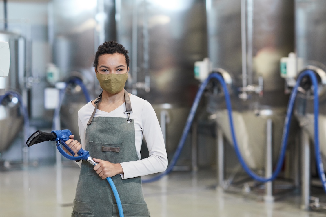 Commercial industrial cleaning services A commercial cleaning professional holding an industrial vacuum.