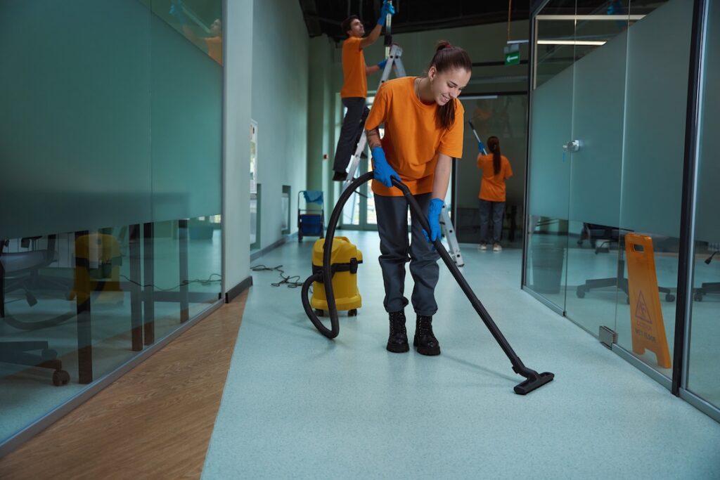 Commercial cleaning company workers washing and cleaning the building.