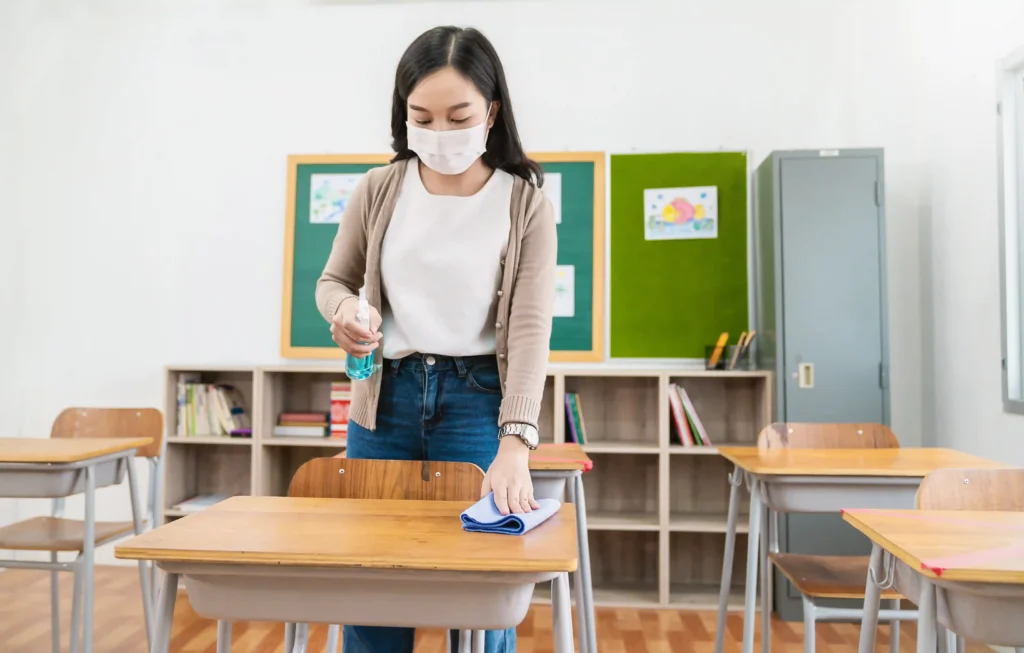woman cleaning a school desk
