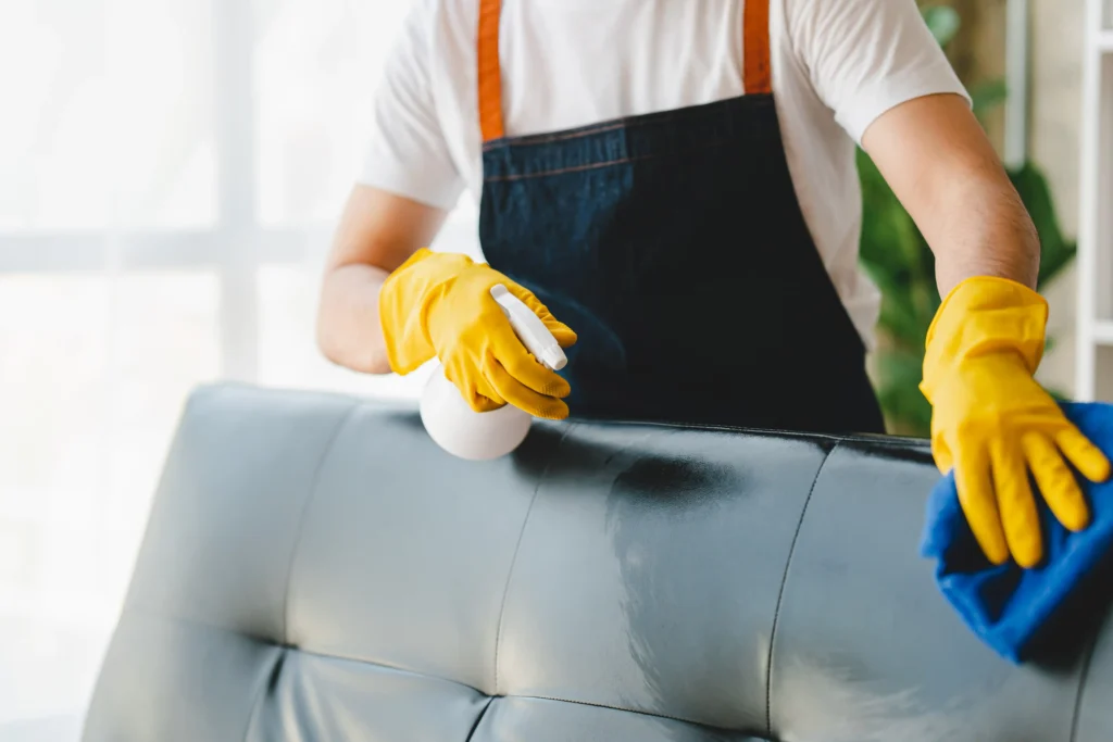 woman cleaning a couch from an office