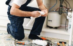 Cropped,Photo,Of,A,Handsome,Young,Man,Plumber,Work,In Cropped photo of a handsome young man plumber work in uniform indoors.