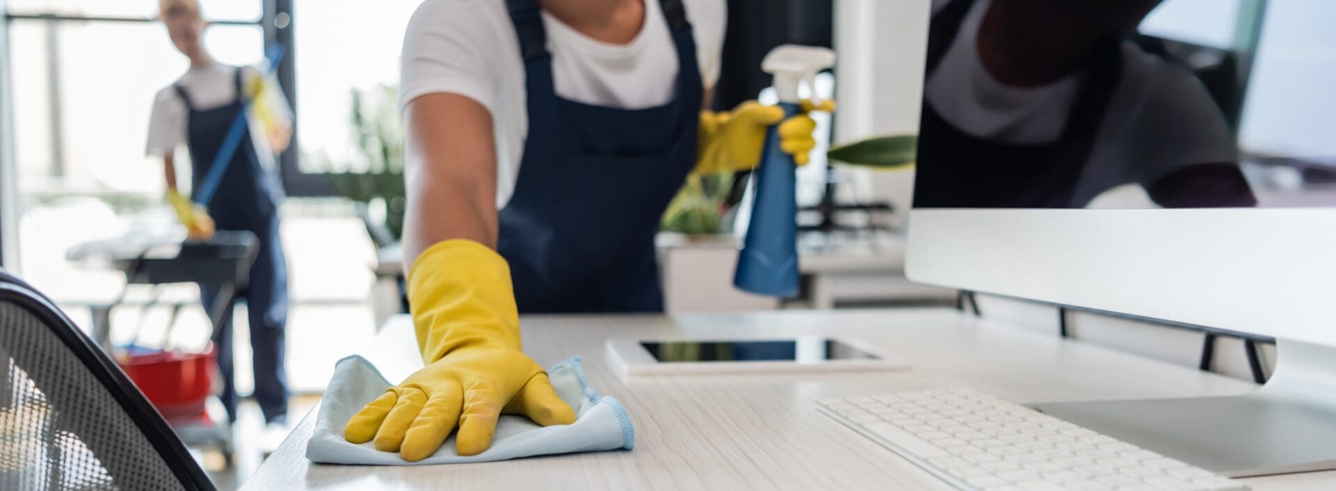 person cleaning a desk