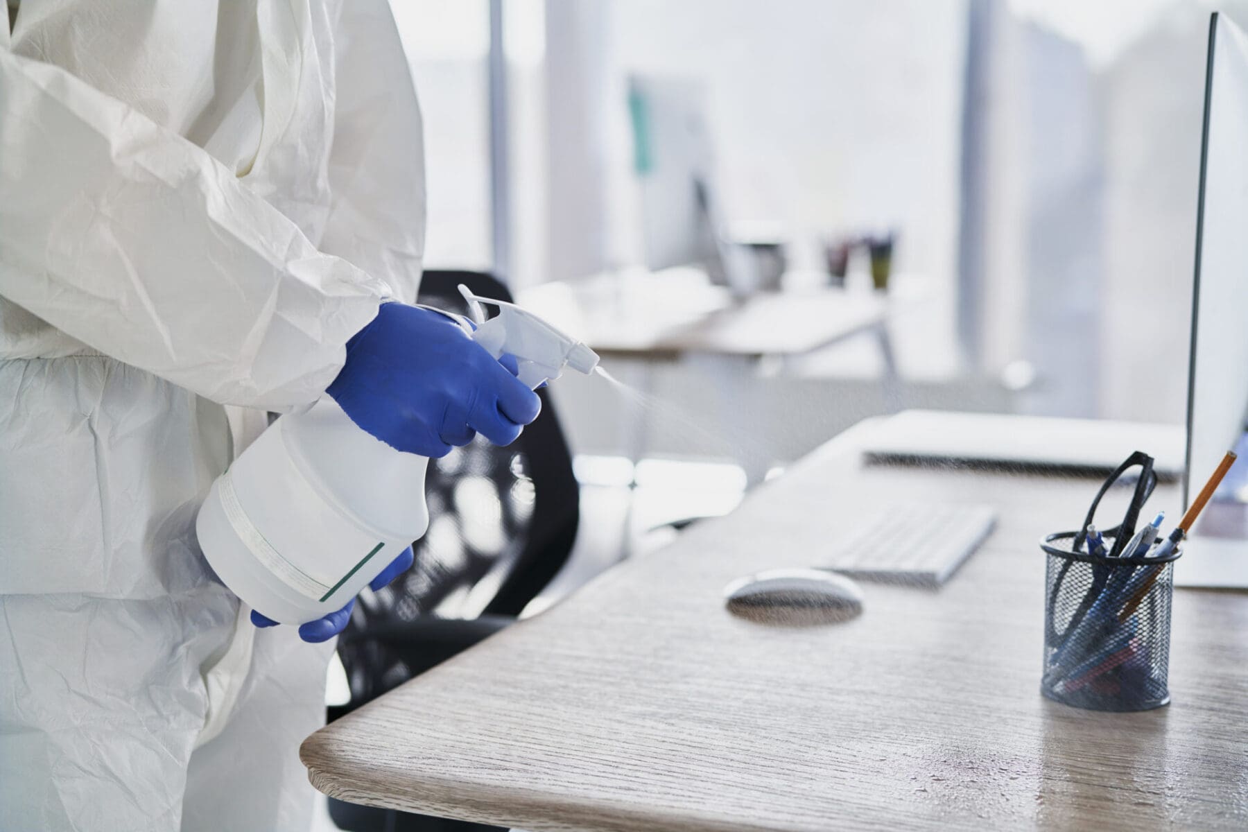 close up human hands cleaning desk