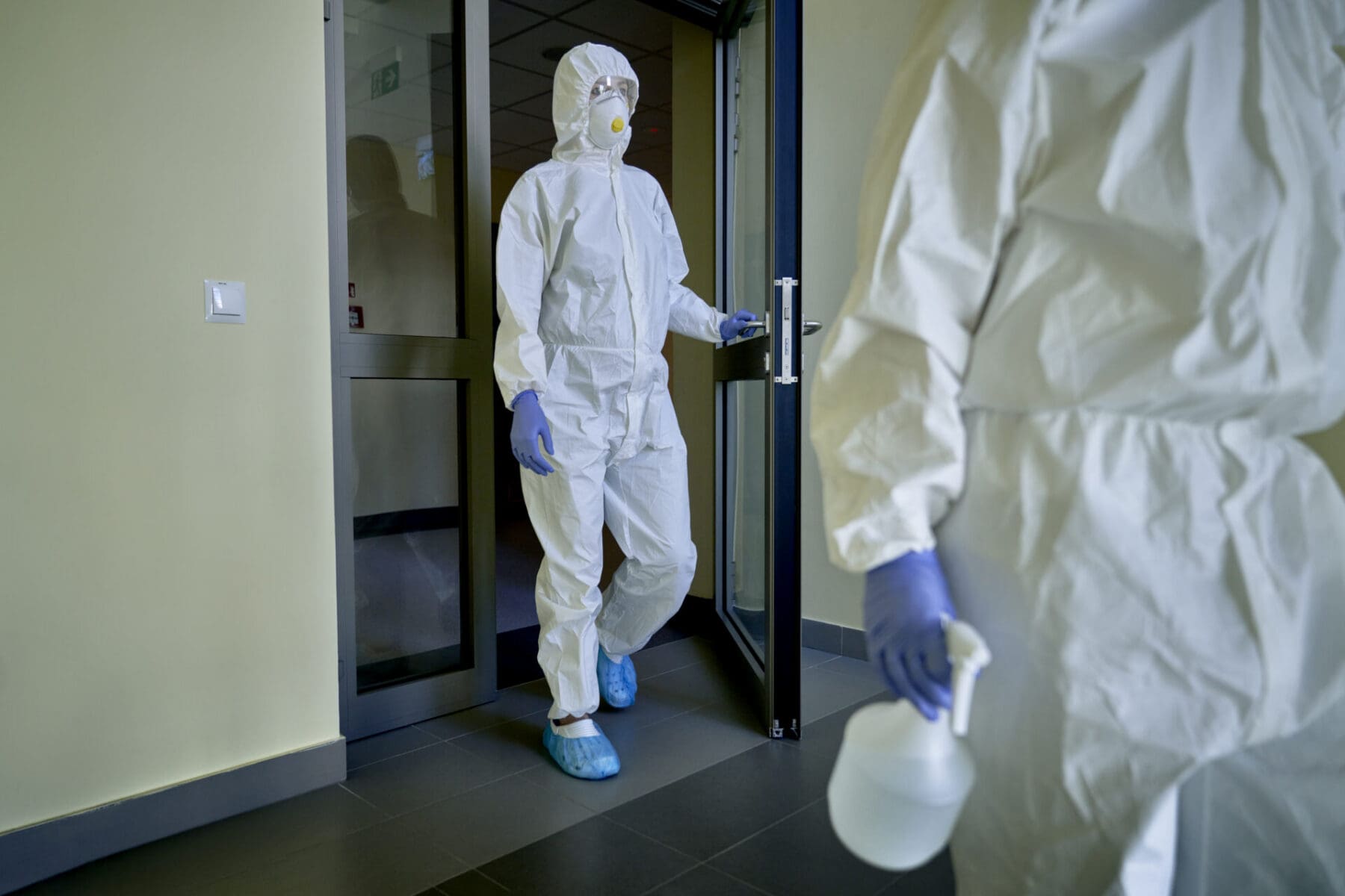 disinfecting team walking into a facility