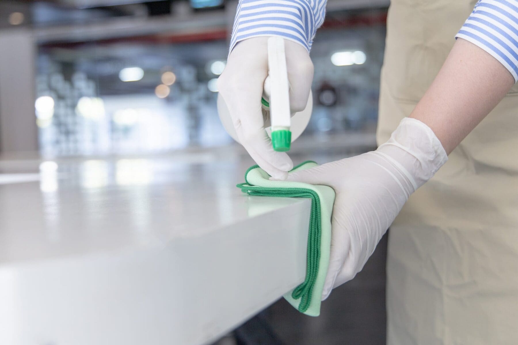person cleaning a table