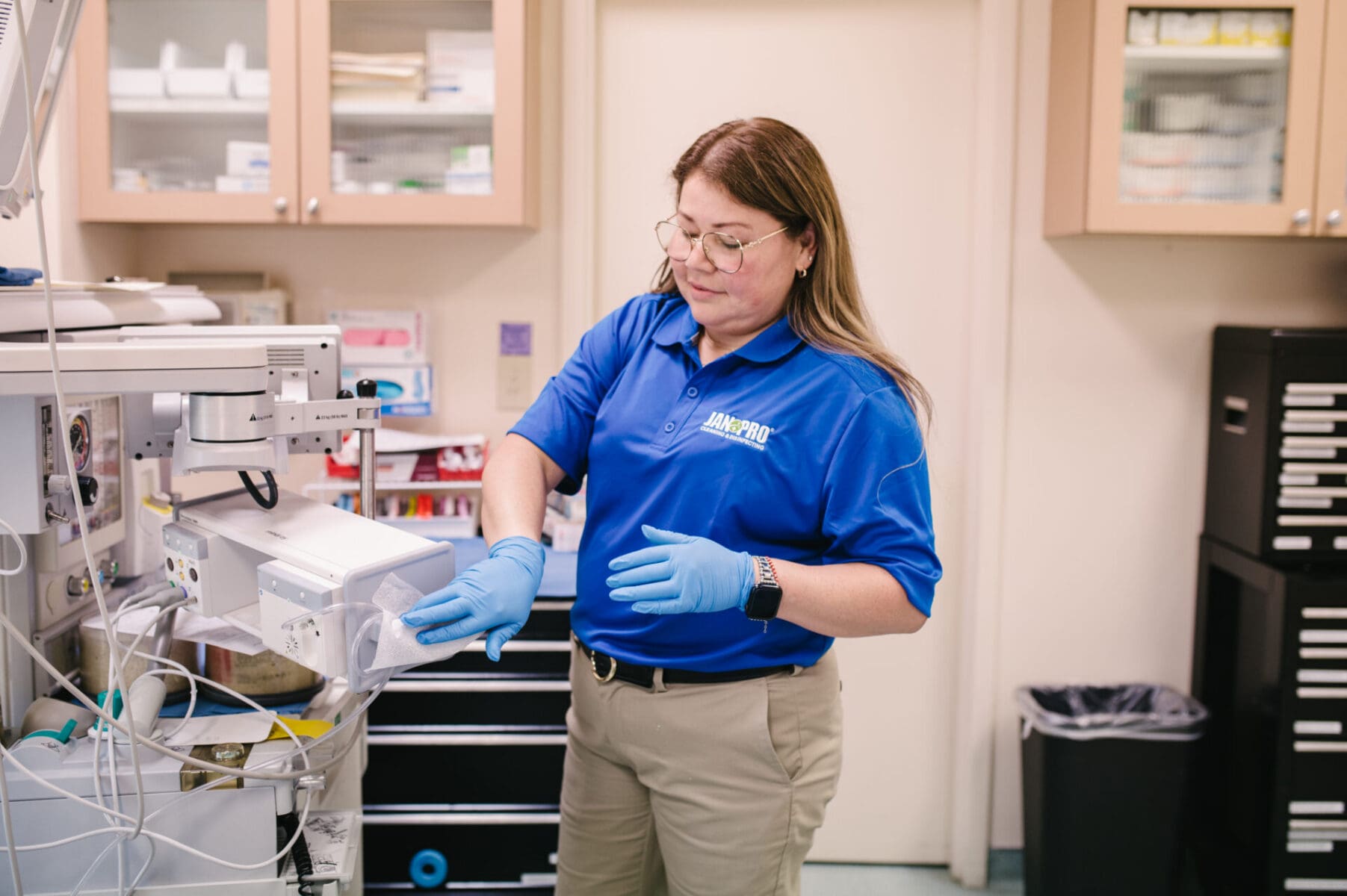 woman cleaning medical equipment