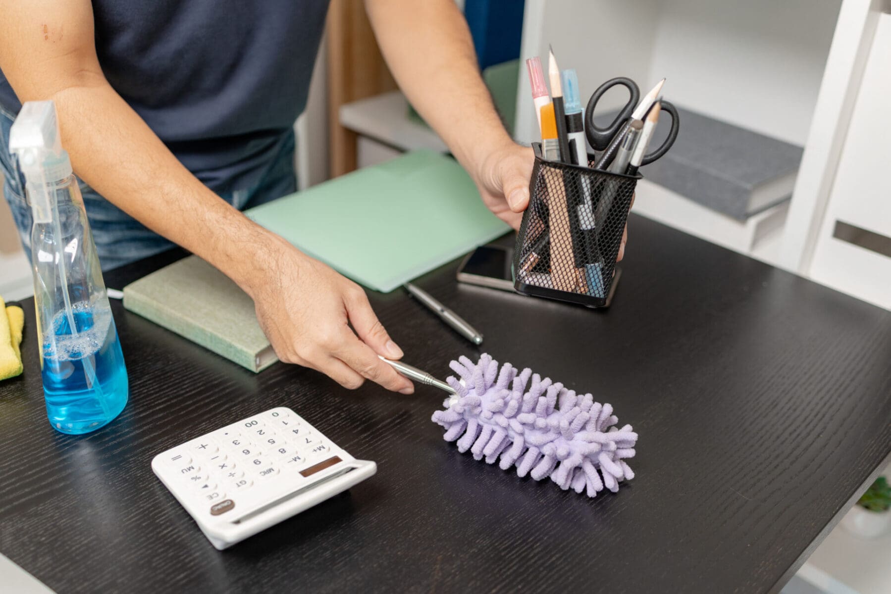 person cleaning desk