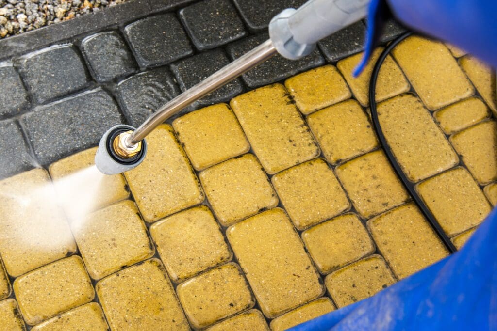 person Power Washing the floor