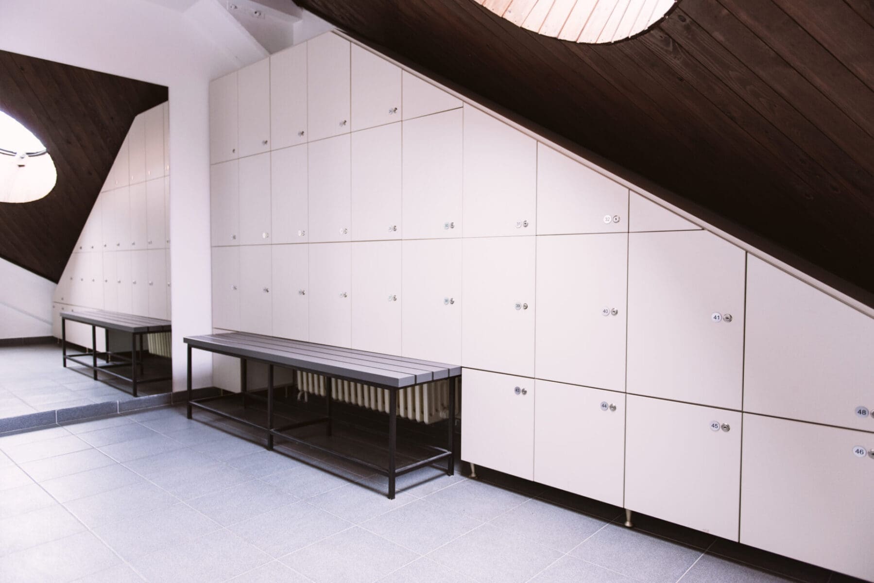 clean locker room interior with bench seating scaled