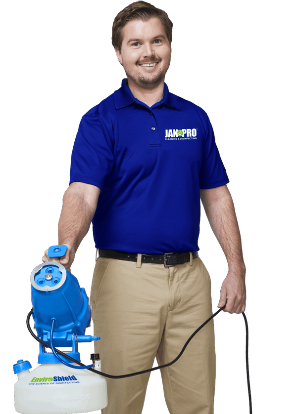 A JAN-PRO Cleaning & Disinfecting owner-operator holding the EnviroShield® sprayer