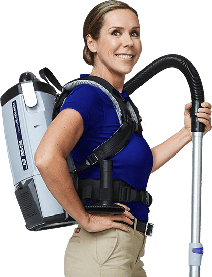A JAN-PRO Cleaning & Disinfecting owner-operator with a backpack vacuum